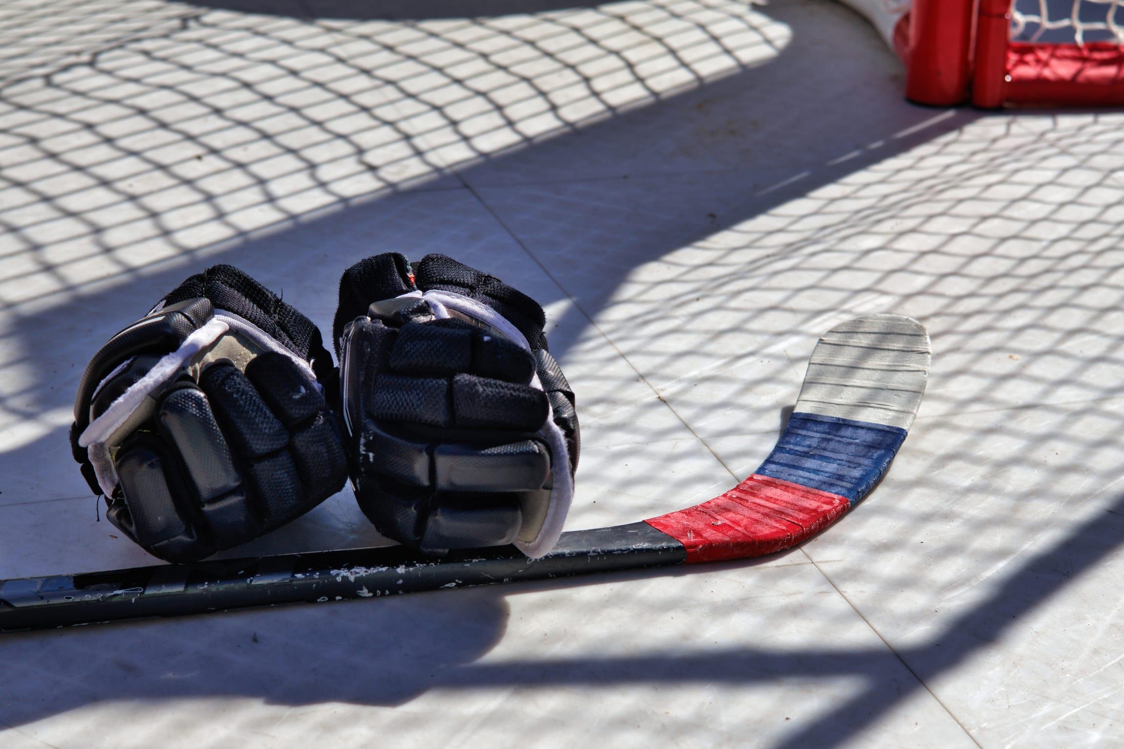 Hockey gloves and stickhandling equipment laid out for off-ice training